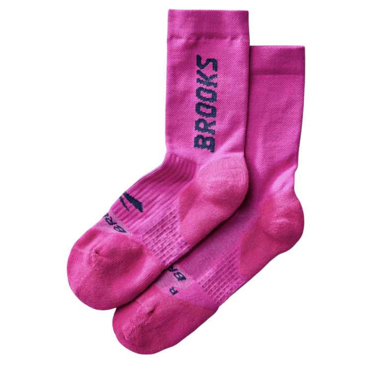 Bright pink socks with \“BROOKS\“ written vertically in bold black letters on the sides.