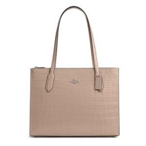 A beige tote bag with an embossed crocodile pattern and the Coach brand logo.