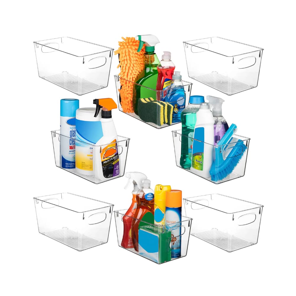 Various clear plastic storage bins containing household cleaning supplies like sprays, sponges, and brushes.