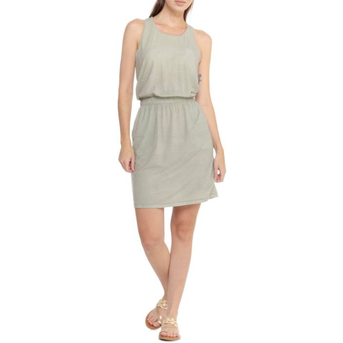 Sleeveless green dress with a relaxed fit, elastic waistband, knee-length hem, and two side pockets. Worn with strappy sandals.