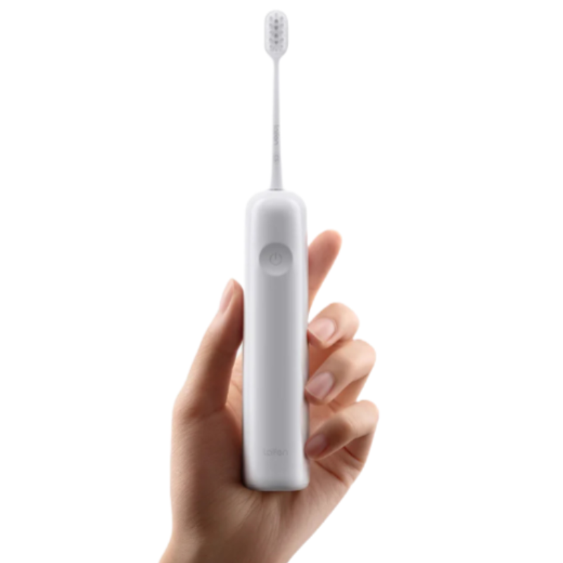 A hand holds a white Laifen Wave Electric Toothbrush with a minimalist design, featuring a single power button on the handle and a slim brush head.