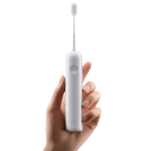 A hand holds a white Laifen Wave Electric Toothbrush with a minimalist design, featuring a single power button on the handle and a slim brush head.