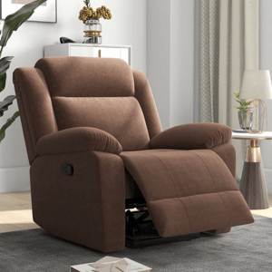 A brown reclining chair with plush cushioning is situated in a cozy living room, featuring a side handle for adjusting the recline. A small side table with a lamp and decorative plant complements the setting.