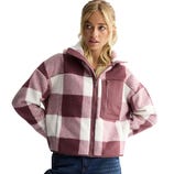 A woman is wearing a zip-up fleece jacket with a pink and white checkered pattern, featuring a front pocket and a high collar.