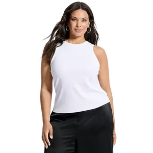 A woman wears a sleeveless white top and black pants, complemented by hoop earrings.