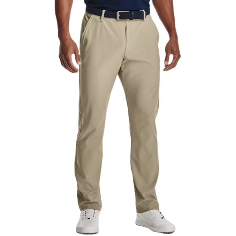 Under Armour Drive Pants are beige, straight-leg trousers featuring a tailored fit, belt loops, and a button closure. They are paired with a dark belt and white sneakers.