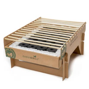 Biodegradable instant grills made from natural materials with bamboo grates and charcoal briquettes, designed for easy disposal and eco-friendly outdoor cooking.