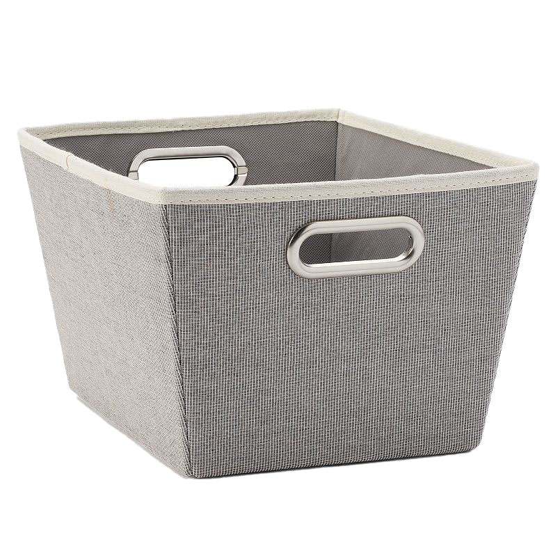 A fabric storage bin with a grey, textured exterior and metal oval handles, designed for organizing or decluttering spaces.