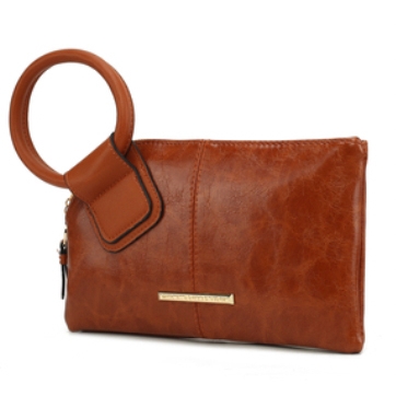 A brown leather clutch with a large circular handle and a metallic nameplate detail.