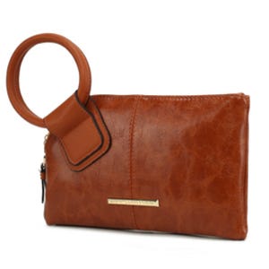 A brown leather clutch with a large circular handle and a metallic nameplate detail.