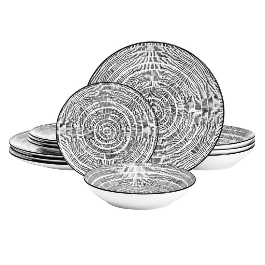 The Pfaltzgraff 12-piece dinnerware set features black and white radial line patterns on plates and bowls. It includes four dinner plates, four salad plates, and four bowls with a modern, textured design.