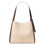 A beige tote bag with a structured design, featuring a brown strap and a minimalist knot detail. The brand logo is subtly displayed at the front.