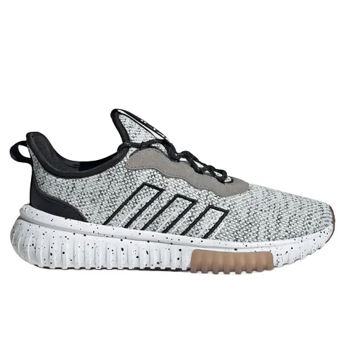 A grey and black athletic shoe with a speckled design, featuring black stripes on the side, a textured white sole with brown accents, and a pull tab at the heel.