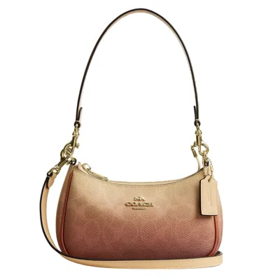 A small, ombre-colored shoulder bag with gold hardware and an adjustable strap, featuring a Coach logo and a leather tag.