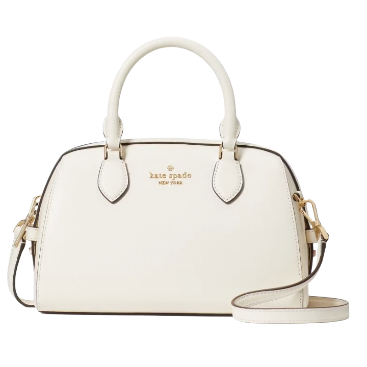 A white Kate Spade New York handbag featuring dual top handles and an adjustable shoulder strap, accented with gold-tone hardware and the brand’s logo embossed on the front.