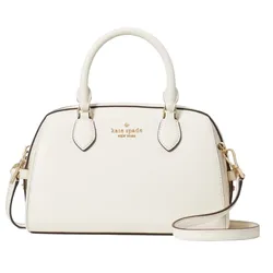 A white Kate Spade New York handbag featuring dual top handles and an adjustable shoulder strap, accented with gold-tone hardware and the brand’s logo embossed on the front.