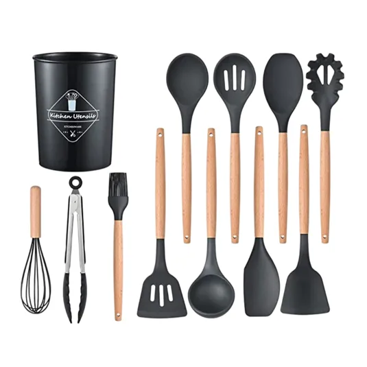 A black kitchen utensil set includes a whisk, tongs, basting brush, and various spoons and spatulas with wooden handles, all stored in a matching black container.