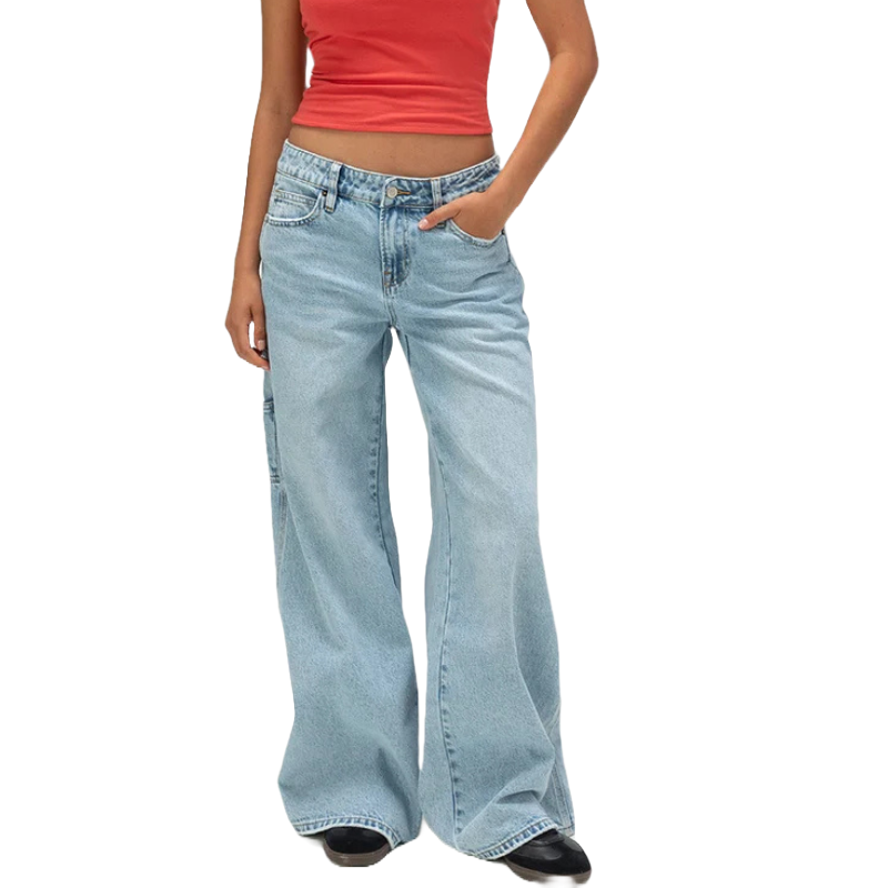 A person is wearing a red tank top and wide-leg light blue jeans.