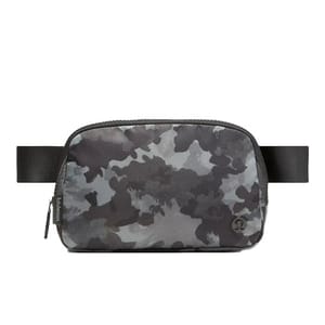 A camouflage-patterned belt bag with a zippered main compartment, featuring a black adjustable strap and subtle branding on the front.