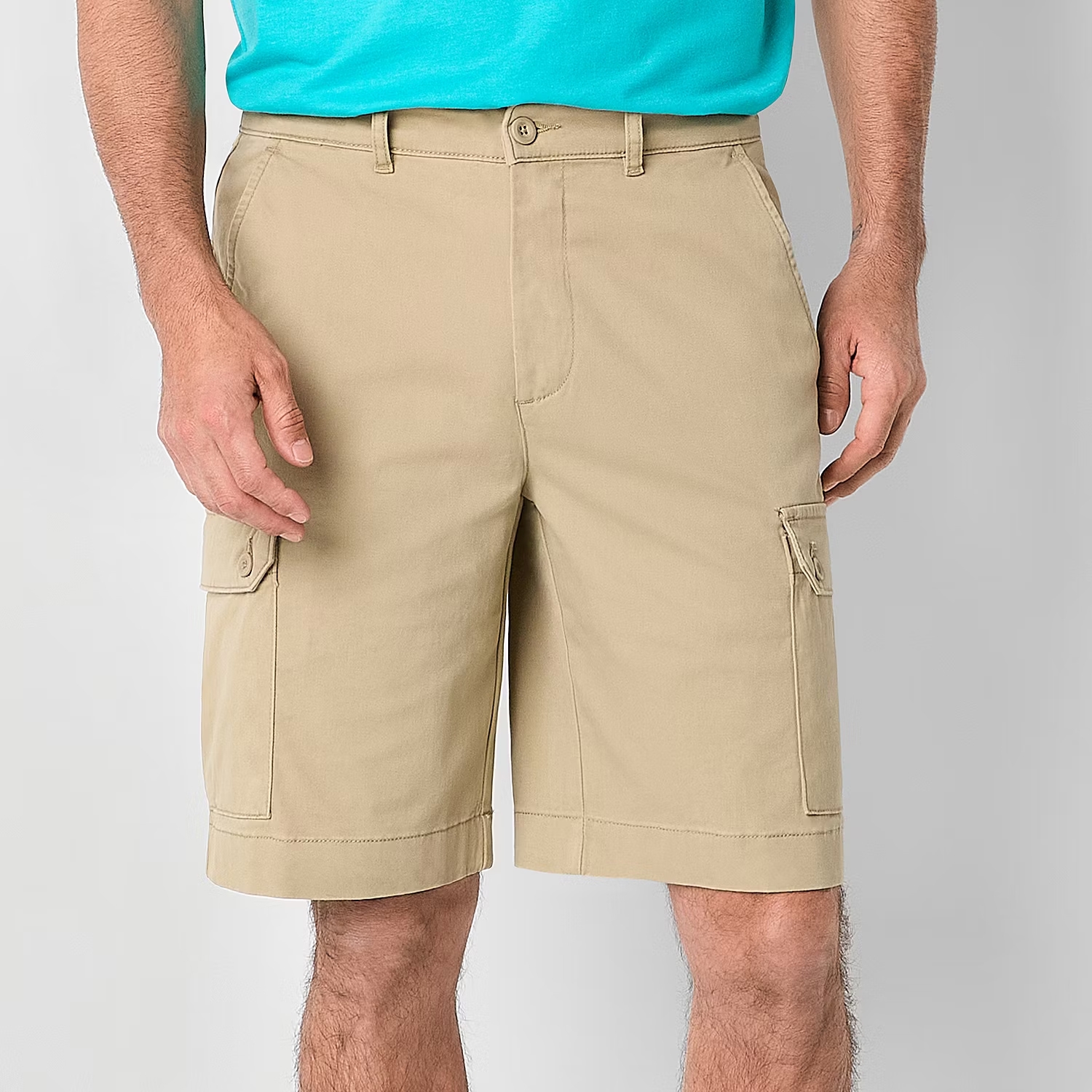 A pair of men's beige cargo shorts with side flap pockets.