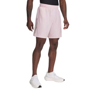 A person is wearing light pink Under Armour shorts with a black logo on the side, paired with white athletic shoes and a black top.