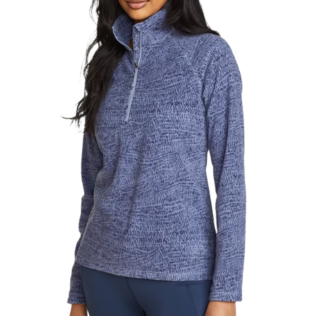 A woman is wearing a blue, textured quarter-zip fleece pullover with long sleeves, suitable for casual or outdoor wear.