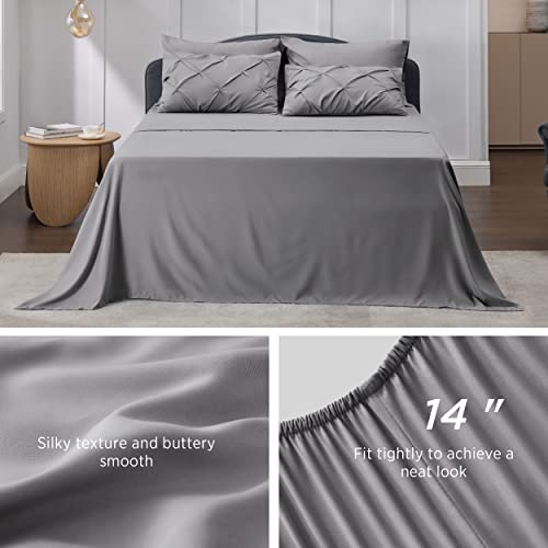 A gray quilted comforter set displayed on a bed with two pillows, highlighting the silky texture and tight fit for a neat look.