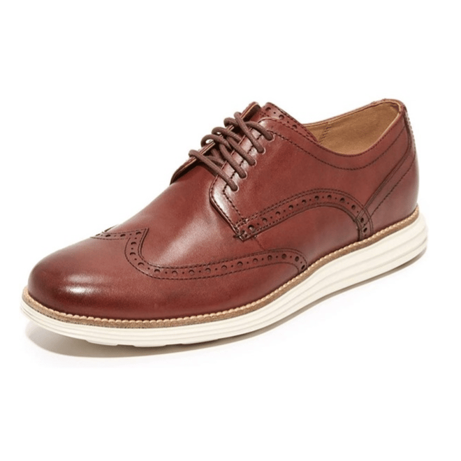 Brown wingtip Oxford shoe with brogue detailing and a white sole.