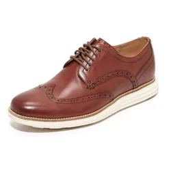 Brown wingtip Oxford shoe with brogue detailing and a white sole.