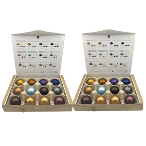 Two boxes containing Nespresso coffee pods of various colors, each arranged in a 5x3 grid. The boxes have labels detailing different coffee types such as espresso, double espresso, gran lungo, and barista creations.