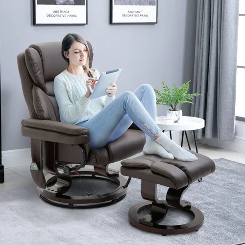 A woman is seated in a brown recliner chair with a matching footrest, holding a tablet.