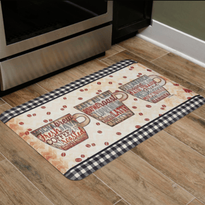 Kitchen floor mat with a coffee theme, featuring three cups adorned with coffee-related words, surrounded by coffee bean motifs and bordered with a black and white checkered pattern.
