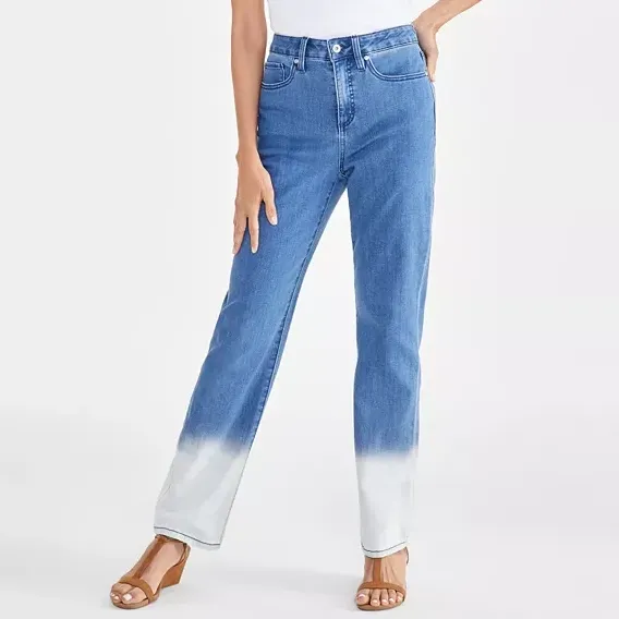 A pair of women's high-rise straight-leg jeans featuring a dip-dye effect transitioning from blue to white at the ankles. The jeans are paired with strappy sandals.
