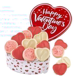 A heart-shaped tin labeled \“Happy Valentine's Day\“ contains assorted heart-shaped cookies in pink, white, and red with sprinkles. The tin features a pattern of hearts.