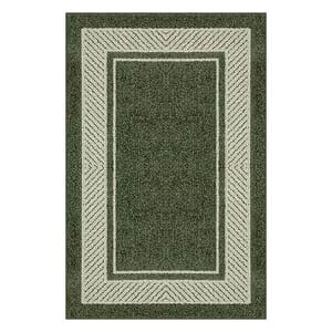 A green rectangular throw rug with a lighter border and a diamond-patterned edge.