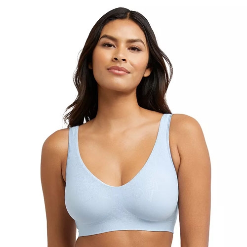 A woman wearing a light blue seamless bra with wide shoulder straps and a scooped neckline.