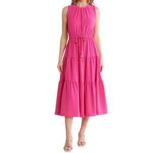 A sleeveless pink midi dress with a gathered neckline, tiered skirt design, and adjustable waist tie. Paired with neutral heeled sandals.