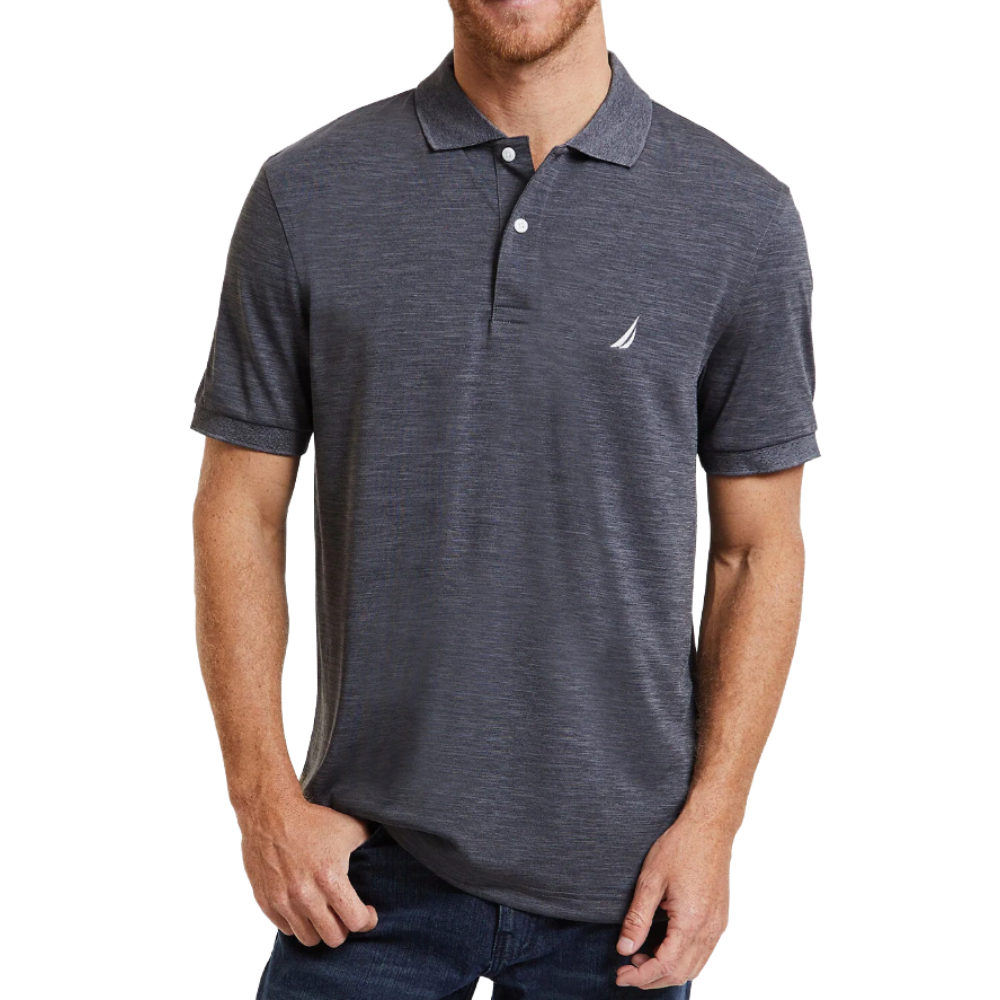 A man is wearing a dark gray polo shirt with a small sailboat logo on the chest, paired with dark jeans.
