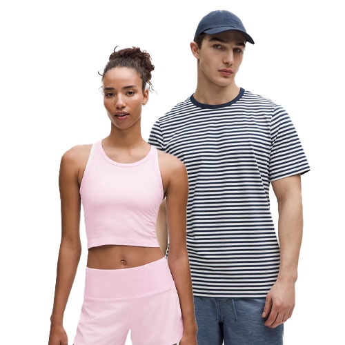 A woman wears a pink athletic tank top and shorts, while a man sports a navy and white striped T-shirt, blue shorts, and a dark blue cap.