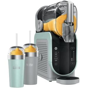 A slushie machine with a transparent container dispensing orange slush, accompanied by two insulated cups with straws labeled \“SLUSHi.\“