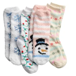 Four pairs of cozy socks with festive designs, including snowflakes, holiday lights, a snowman, and colorful snowflakes, in soft winter colors.
