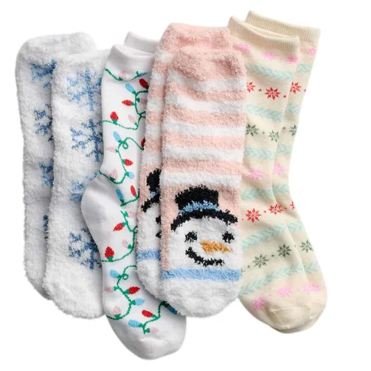 Four pairs of cozy socks with festive designs, including snowflakes, holiday lights, a snowman, and colorful snowflakes, in soft winter colors.