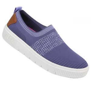 Ryka Vista Slip-On Sneakers feature a purple knit upper with a contrasting white sole and brown accents on the heel. They offer a slip-on design for convenience and a textured pattern for added style.