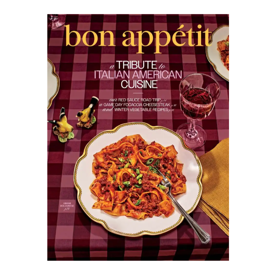Bon Appétit magazine cover featuring a tribute to Italian American cuisine, showcasing a plate of pasta with bolognese sauce and a glass of red wine on a checkered tablecloth.