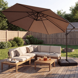 A beige outdoor sectional sofa set on a wooden deck includes a cushioned corner arrangement, a wooden coffee table with drinks, and a large cantilever umbrella providing shade.