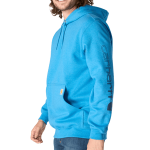 Blue Carhartt hoodie with a front pocket and logo on the sleeve, paired with jeans.