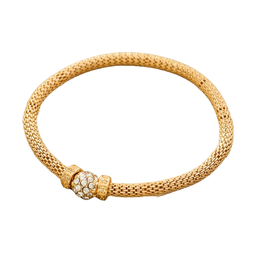 Gold mesh bracelet with a sparkling bead encrusted with clear stones at the center.