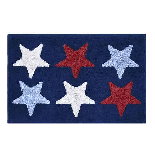 A rectangular rug with a blue background features six textured stars in red, white, and light blue, arranged in two rows of three.