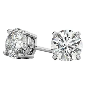 A pair of round-cut diamond stud earrings set in a four-prong metal setting.