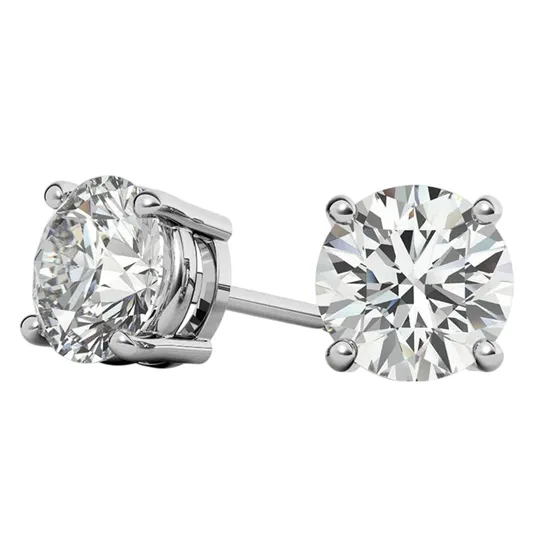 A pair of round-cut diamond stud earrings set in a four-prong metal setting.
